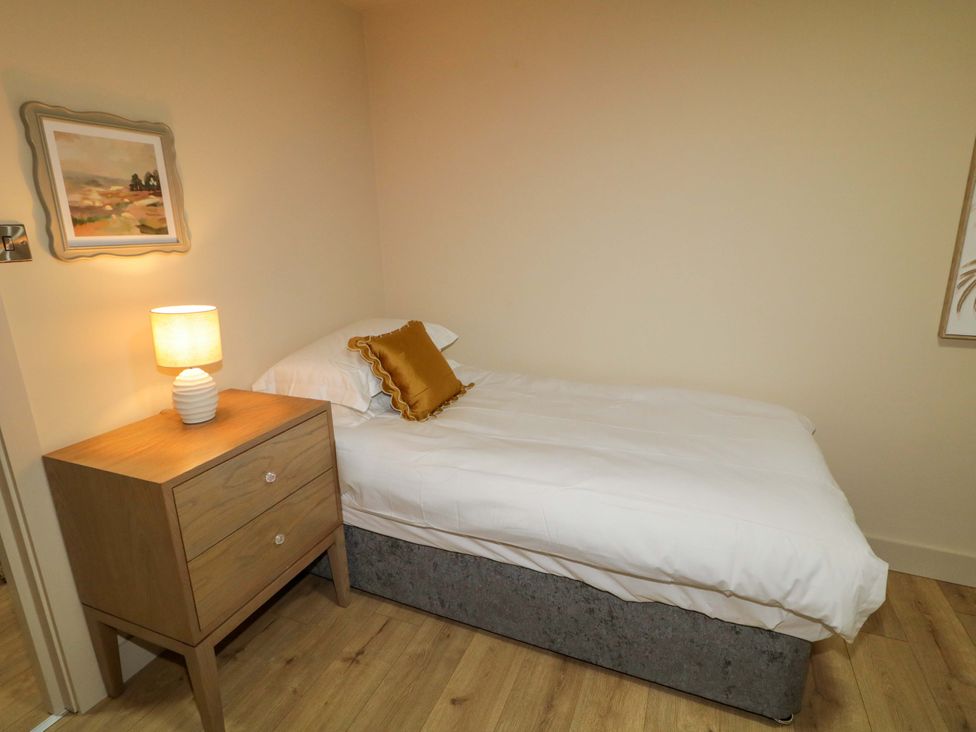 A bedroom with a single bed and nightstand at Apartment 2 in Derry