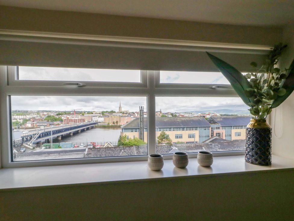 A window with vases and a view of a bridge at Apartment 2 in Derry
