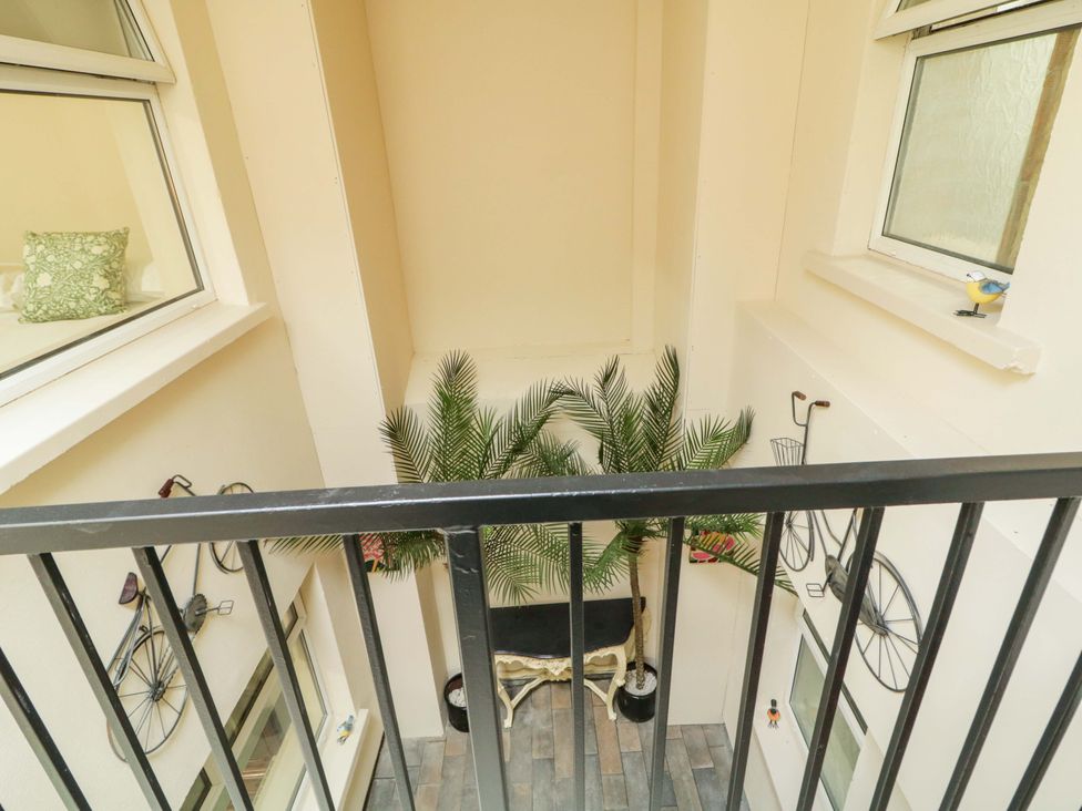 A balcony overlooking a decorated indoor space at Apartment 2 in Derry