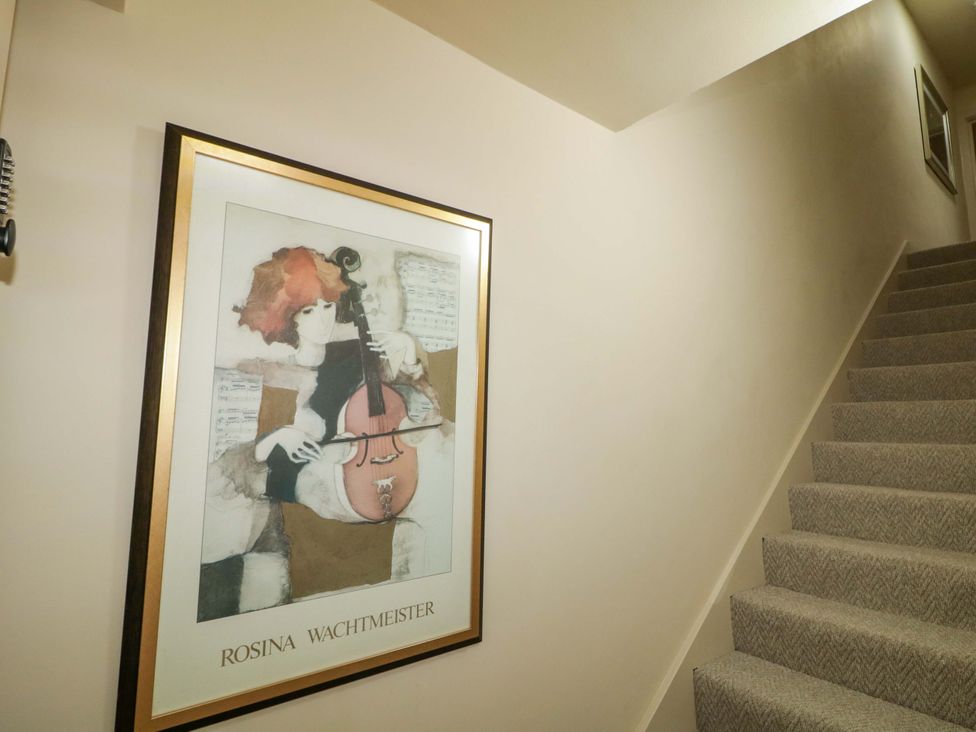 A staircase with a framed artwork on the wall at Apartment 2 Derry