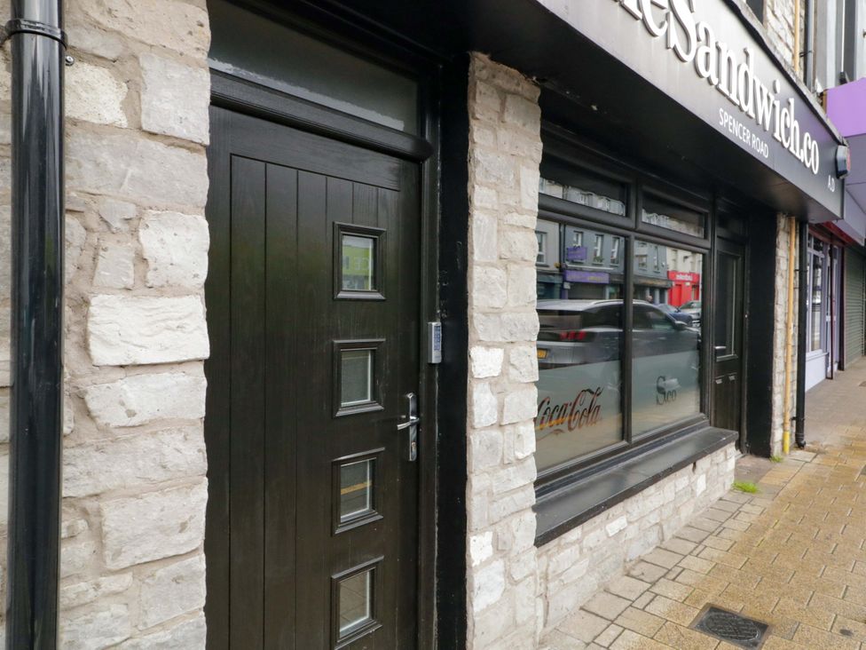 A door and window of a shop front at The Sandwich in Derry