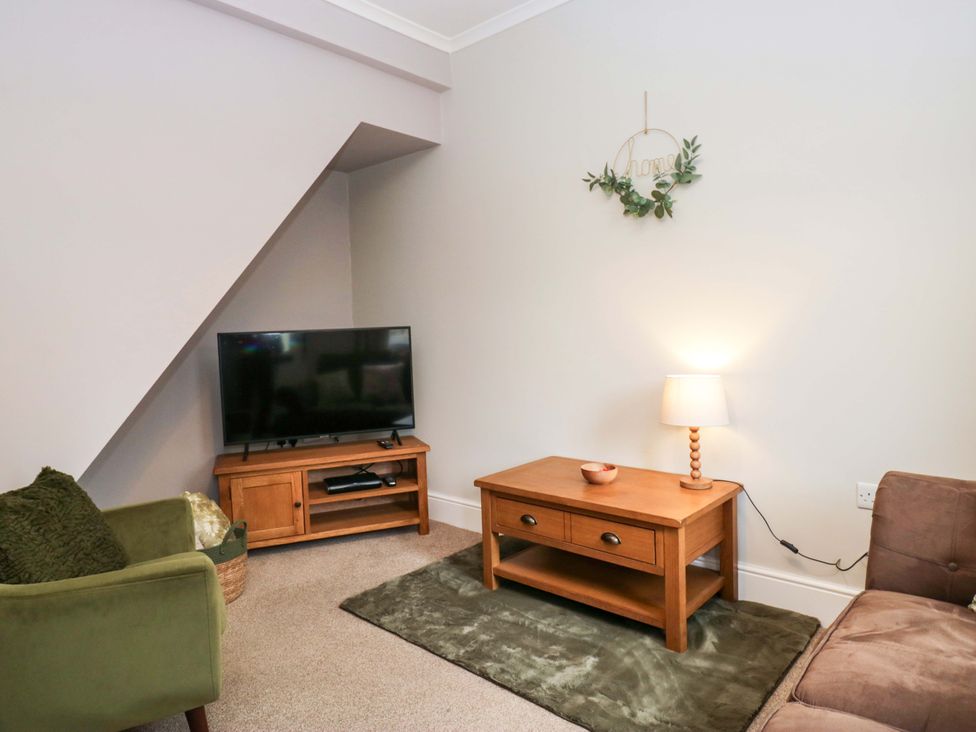 A living room with a television and coffee table at Tethera in Ennerdale