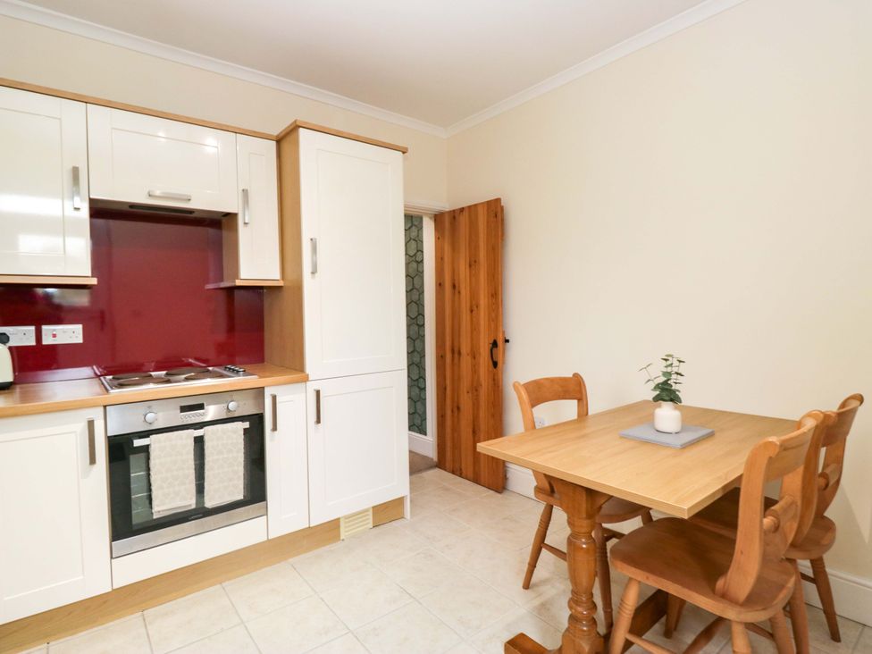 A kitchen with a table and chairs at Tethera in Ennerdale