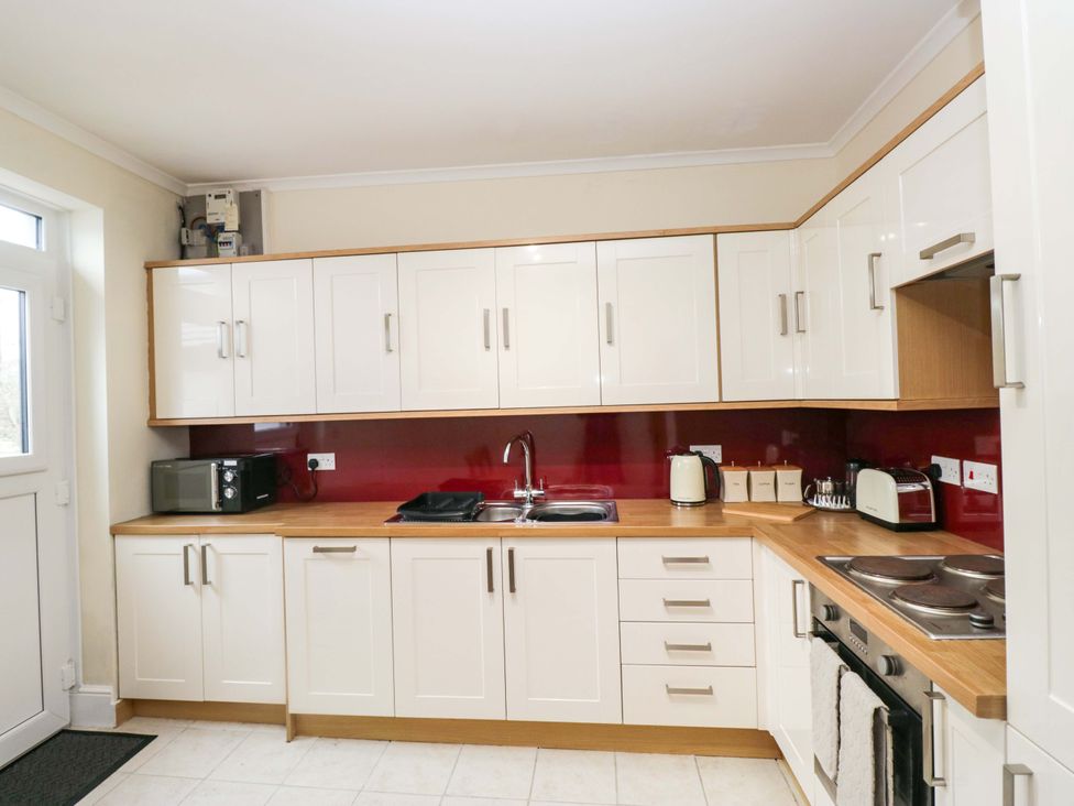 A kitchen with a sink and appliances at Tethera in Ennerdale