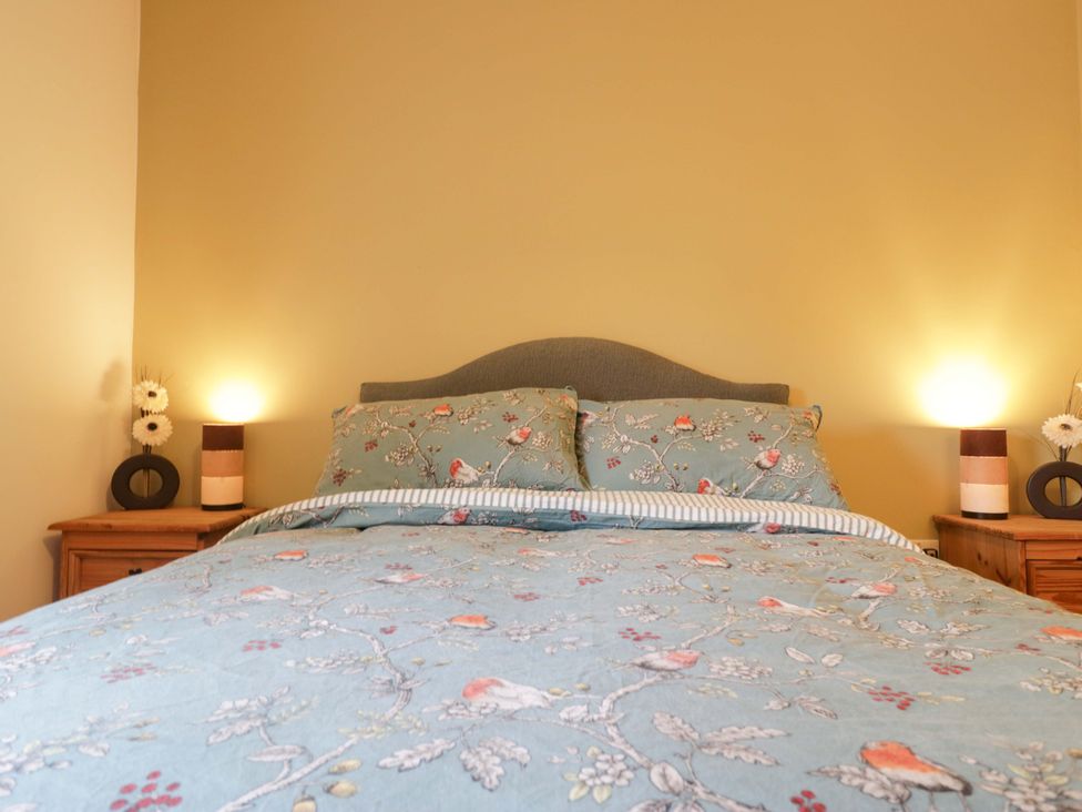 A bedroom with a bed and bedside tables at Tethera in Ennerdale