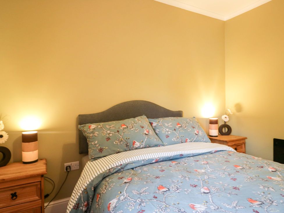 A bedroom with a bed and bedside tables at Tethera in Ennerdale