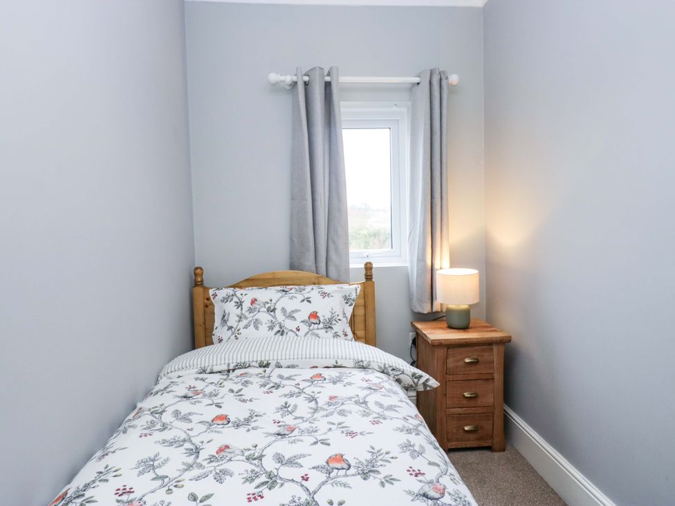 A bedroom with a bed and lamp at Tethera in Ennerdale