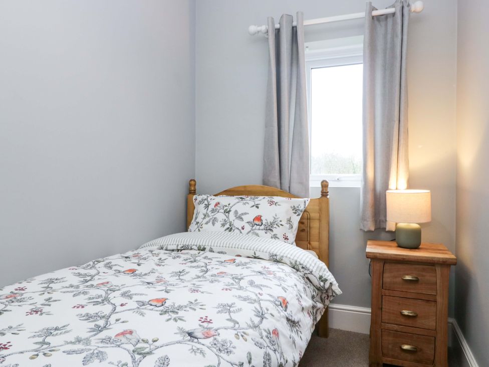 A bedroom with a bed and nightstand at Tethera in Ennerdale