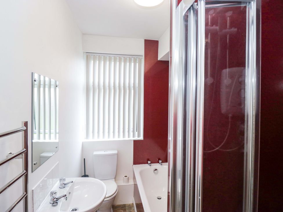 A bathroom with a bathtub and shower at Tethera in Ennerdale