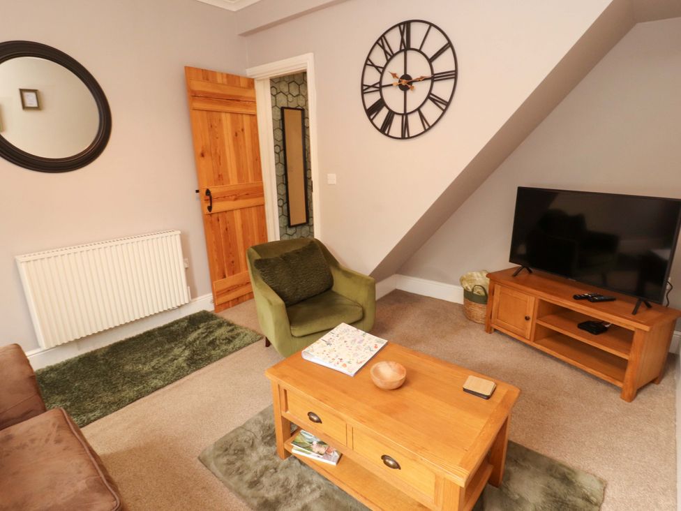 A living room with a sofa and TV at Tethera in Ennerdale