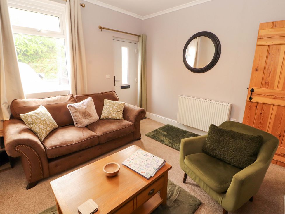A living room with a sofa and armchair at Tethera in Ennerdale