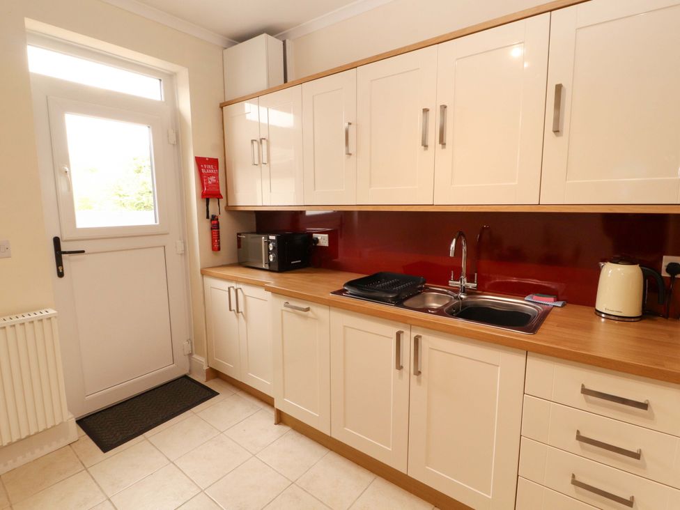 A kitchen with cabinets and appliances at Tethera in Ennerdale