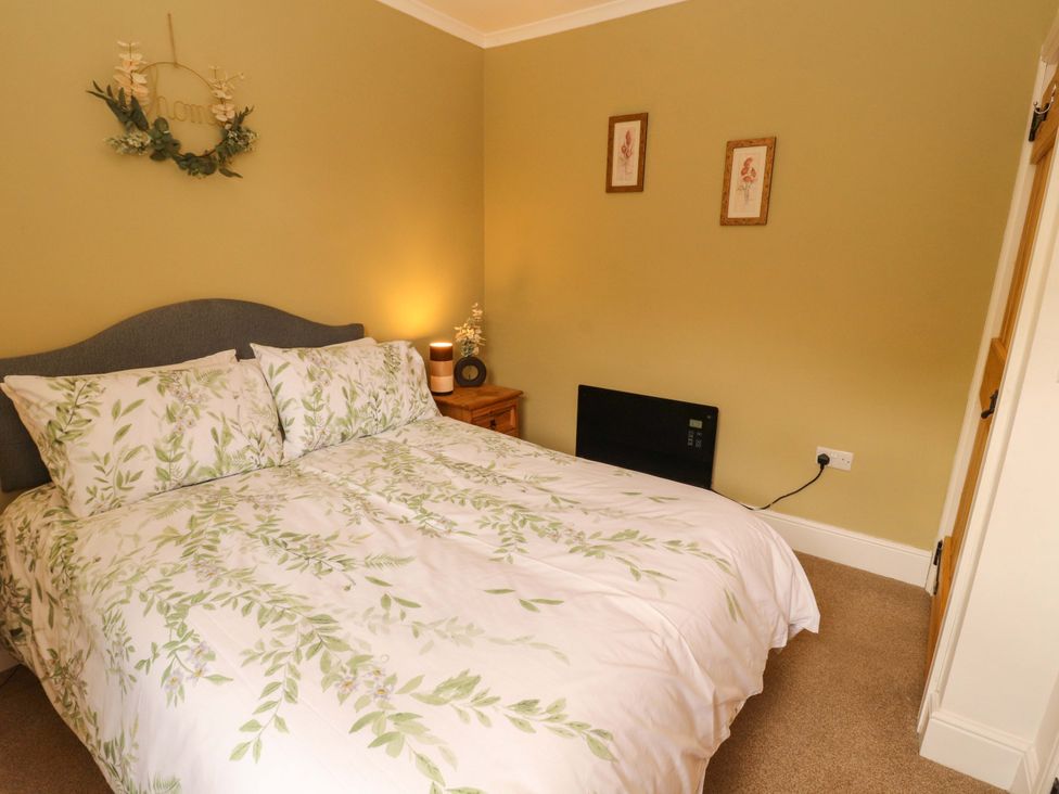 A bedroom with a bed and nightstand at Tethera in Ennerdale