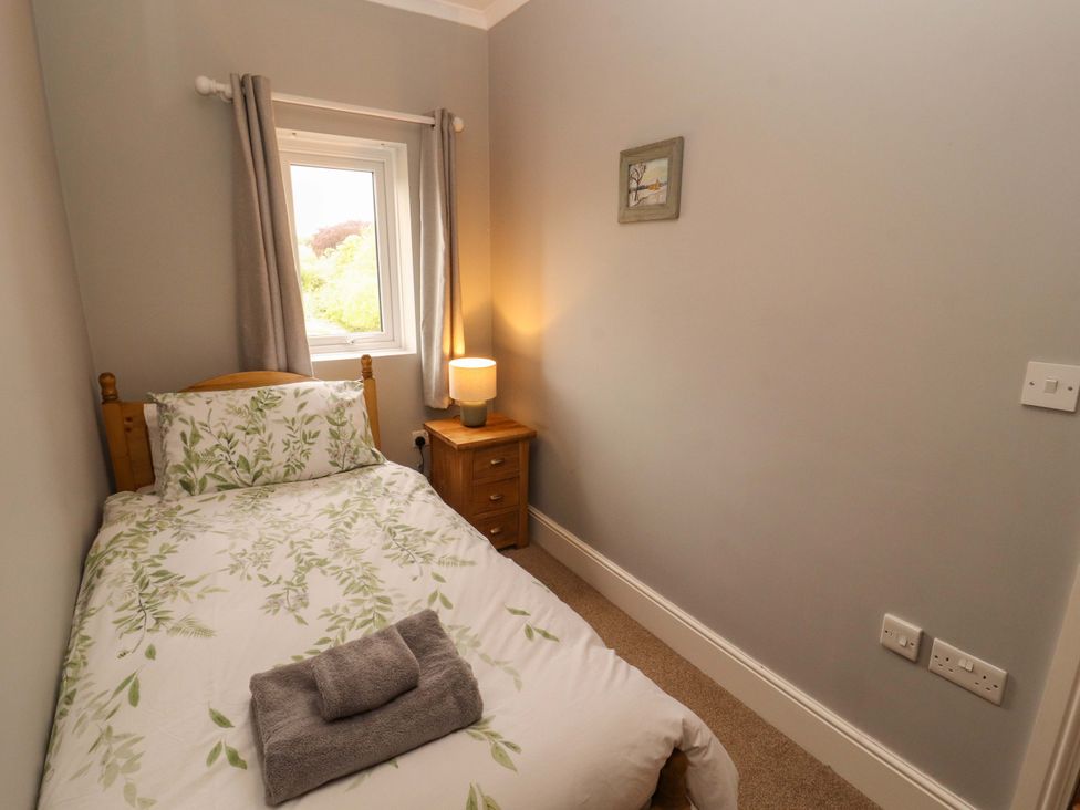A bedroom with a single bed and bedside table at Tethera in Ennerdale