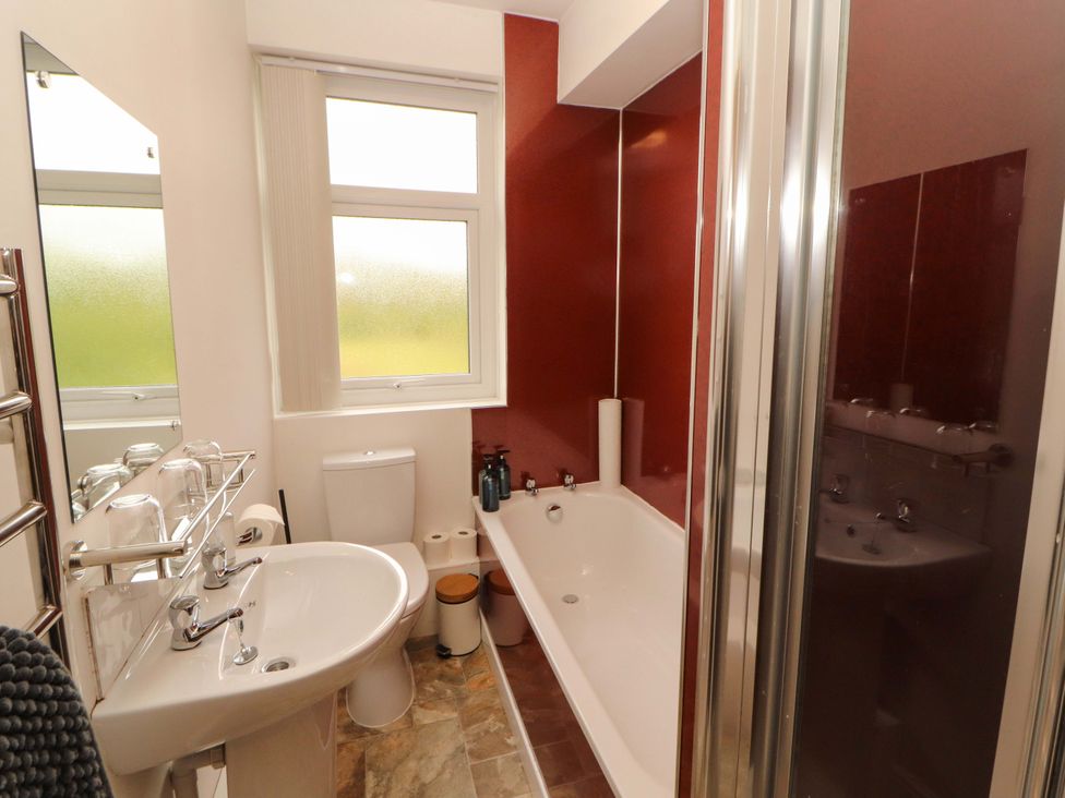 A bathroom with a bathtub, toilet, and sink at Tethera in Ennerdale