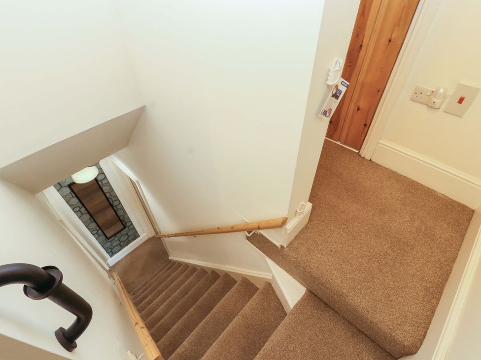 A staircase leading to a door at Tethera in Ennerdale