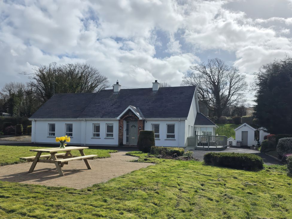A house with a picnic table and garden at An Grianan Getaway in Burt