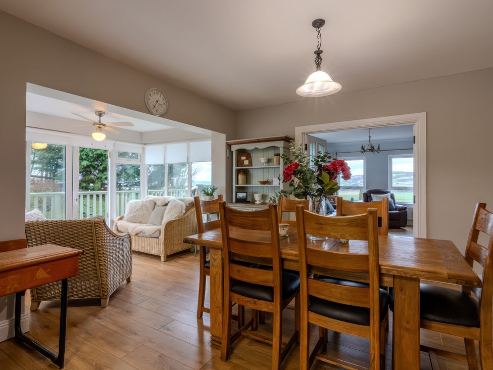 A dining area with a table and chairs at An Grianan Getaway in Burt