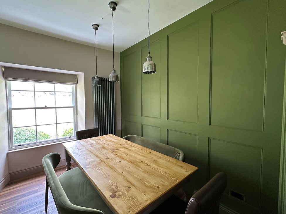 A dining room with a wooden table and chairs at Kirkstone Brow in Ambleside