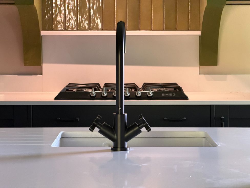 A kitchen with a sink and gas stove at Kirkstone Brow in Ambleside