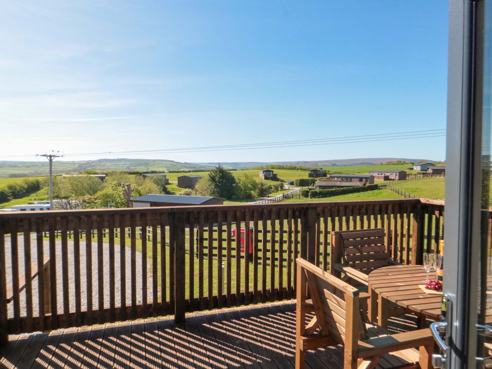 A decking area with table and chairs at Heather Heights in Whitby