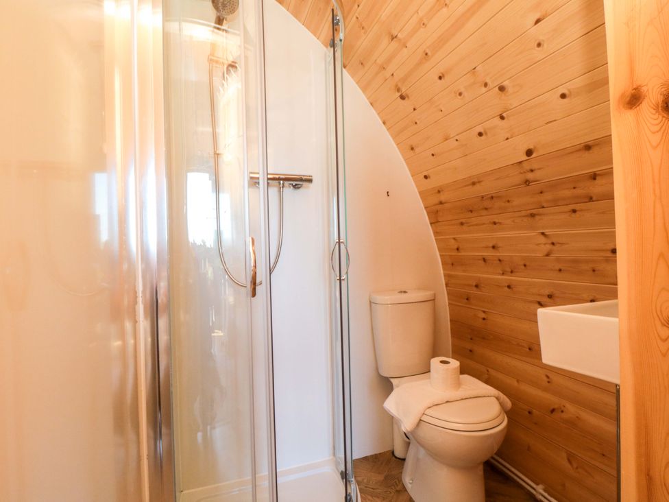 A bathroom with a shower, toilet, and sink at Heather Heights in Whitby