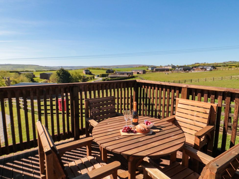 A deck with an outdoor table and chairs at Heather Heights in Whitby