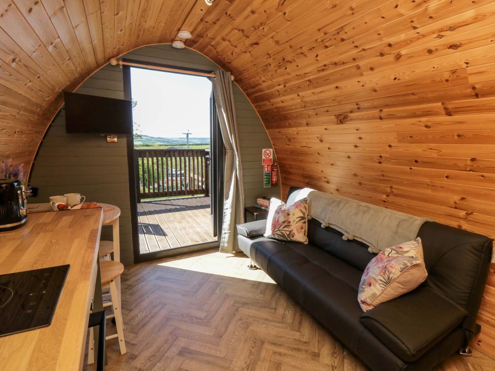 A living room with a sofa and television at Rosemary Retreat in Whitby