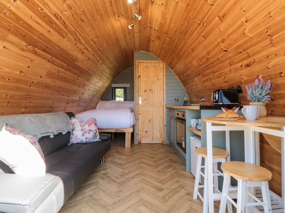 A living room with kitchenette and sofa at Rosemary Retreat in Whitby