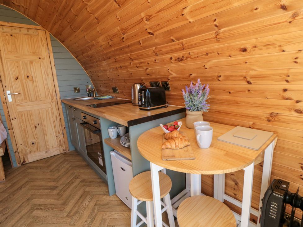A kitchen with a countertop, sink, and dining table at Rosemary Retreat in Whitby