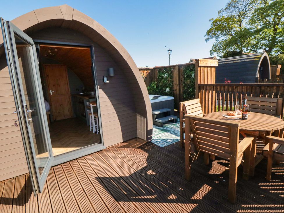 An outdoor area with seating and a hot tub at Rosemary Retreat in Whitby