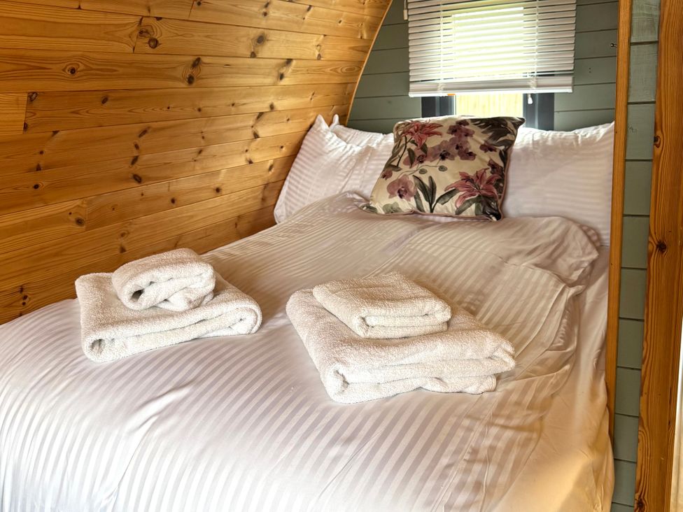 A bedroom with a bed and towels at Sage Sanctuary in Whitby