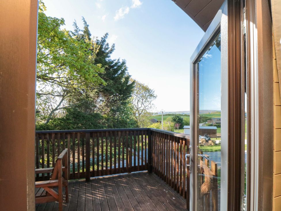 A balcony view overlooking trees and landscape at Sage Sanctuary in Whitby