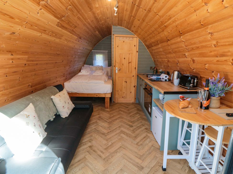 A living room with a bed and kitchenette at Sage Sanctuary in Whitby