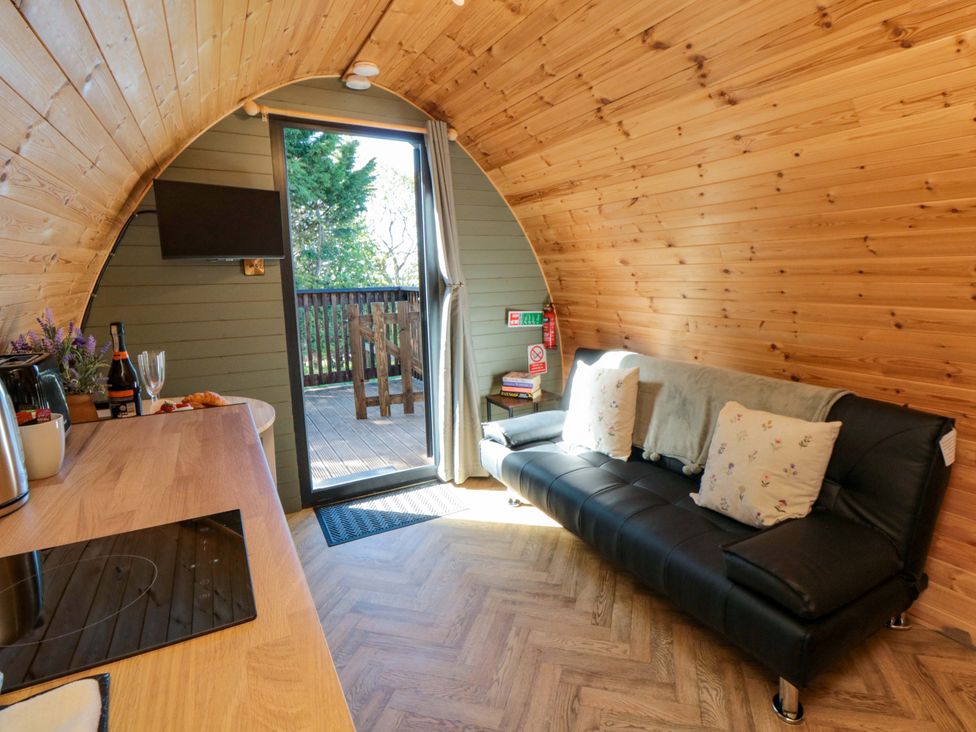 A snug with a sofa and television at Sage Sanctuary in Whitby