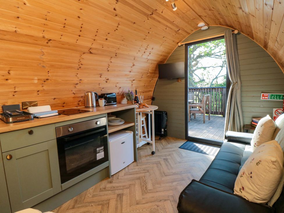A kitchen area with appliances and a seating area at Sage Sanctuary in Whitby
