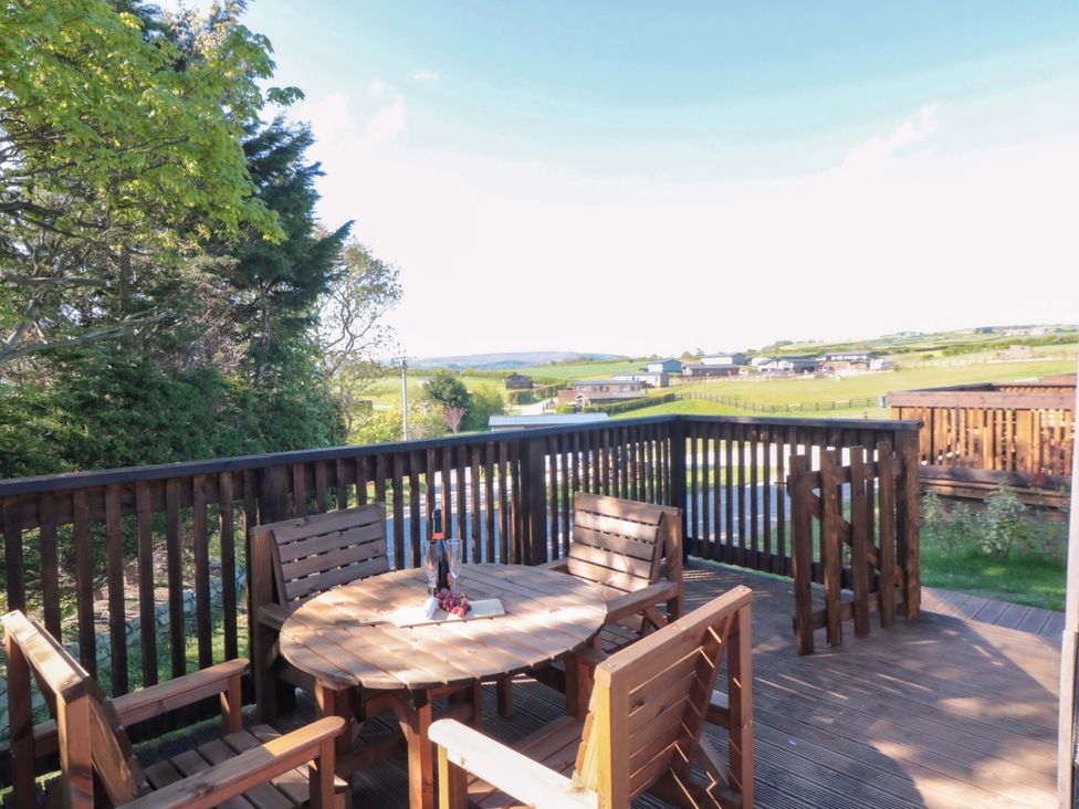 A deck with a table and chairs at Sage Sanctuary in Whitby