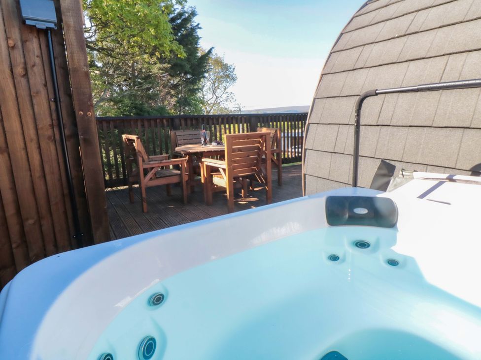 A hot tub next to wooden seating area at Sage Sanctuary in Whitby