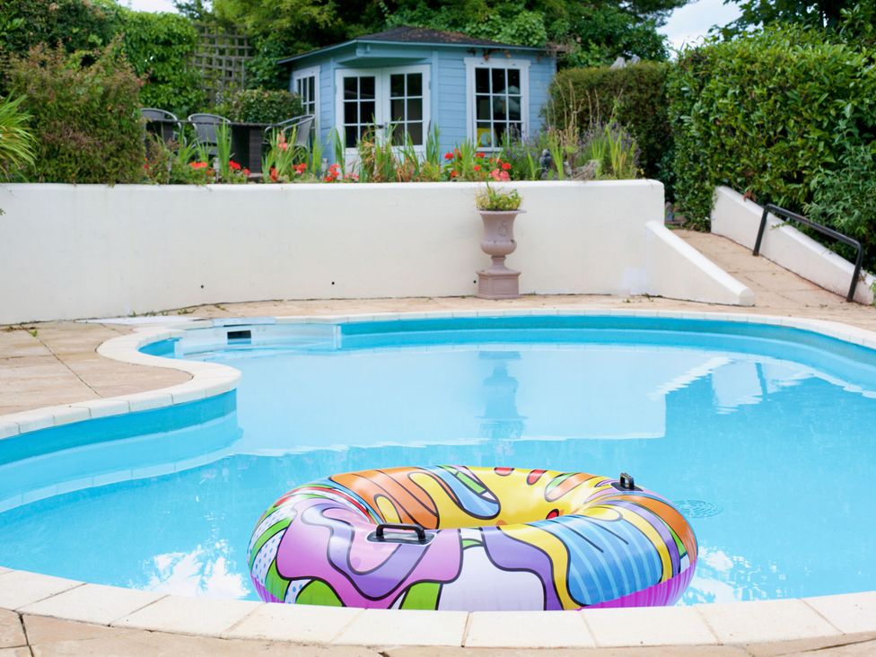 An outdoor area with a swimming pool and an inflatable ring at Apartment 2 in Torquay