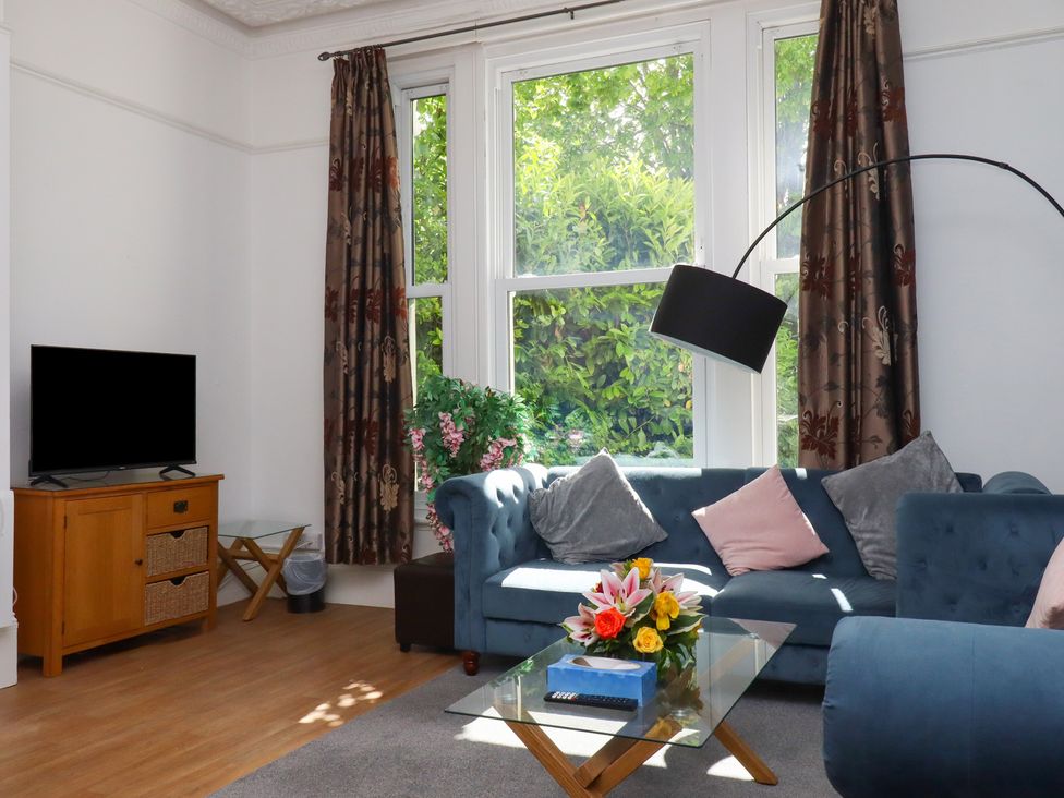 A living room with a sofa and television at Apartment 2 in Torquay