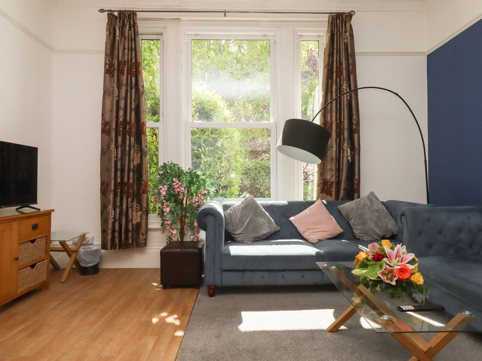 A living room with a sofa and television at Apartment 2 in Torquay