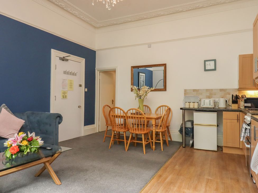 A kitchen with dining area and sofa at Apartment 2 in Torquay