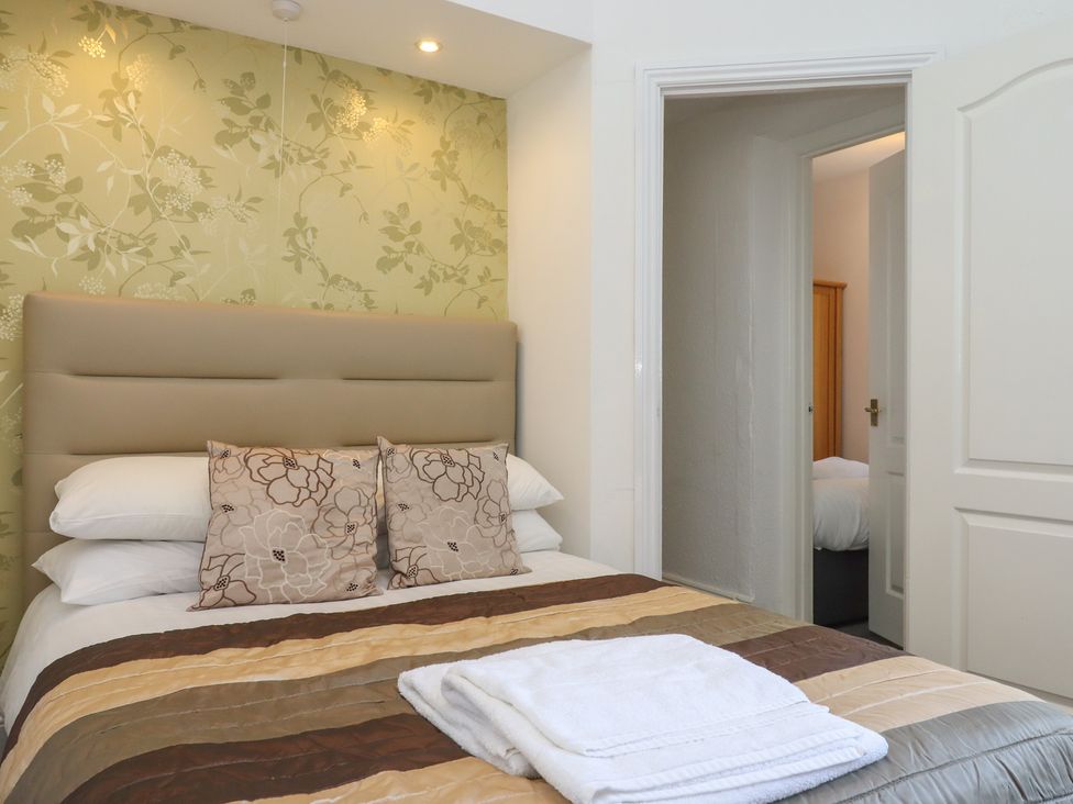 A bedroom with a bed and pillows at Apartment 2 in Torquay