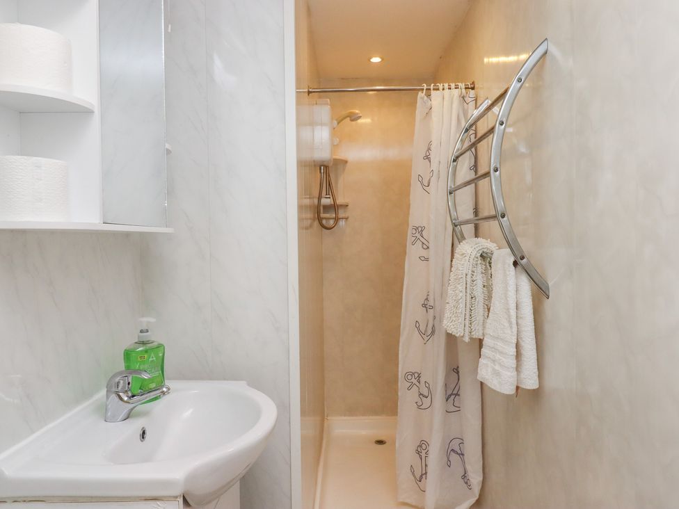 A bathroom with a shower and sink at Apartment 2 in Torquay