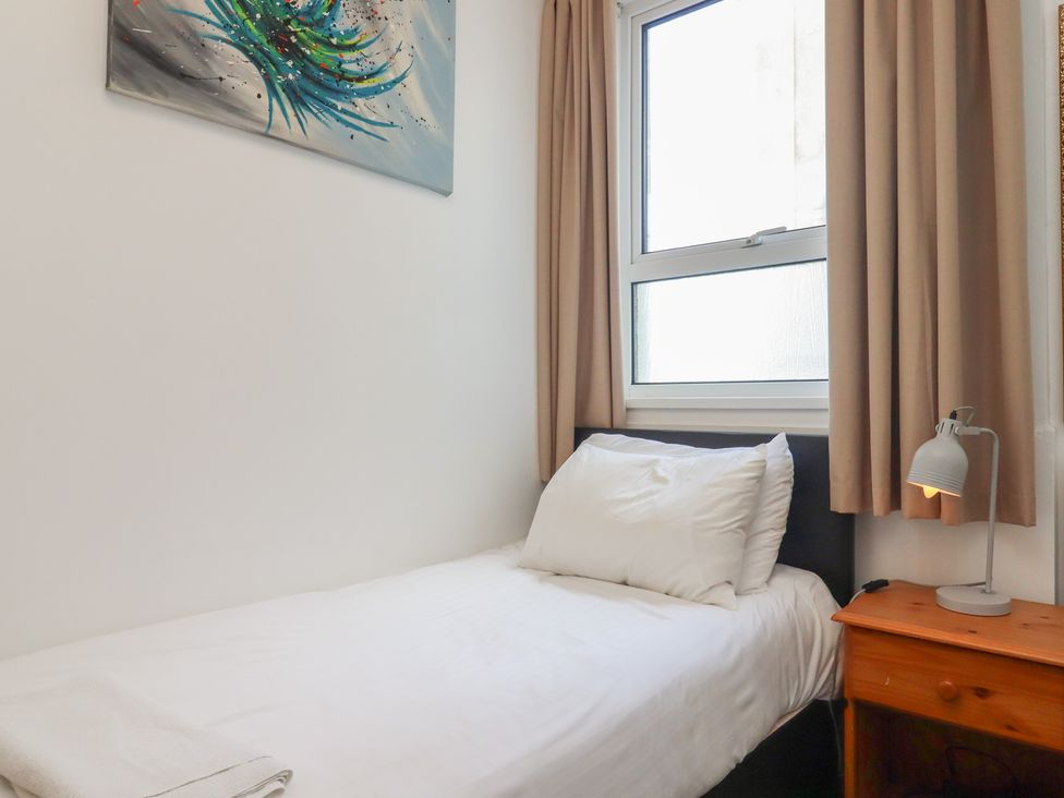 A bedroom with a bed and lamp at Apartment 2 in Torquay