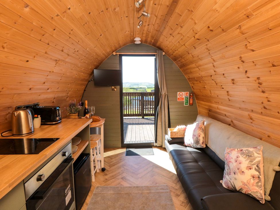 A seating area with a sofa and kitchenette at Fern Folly in Whitby