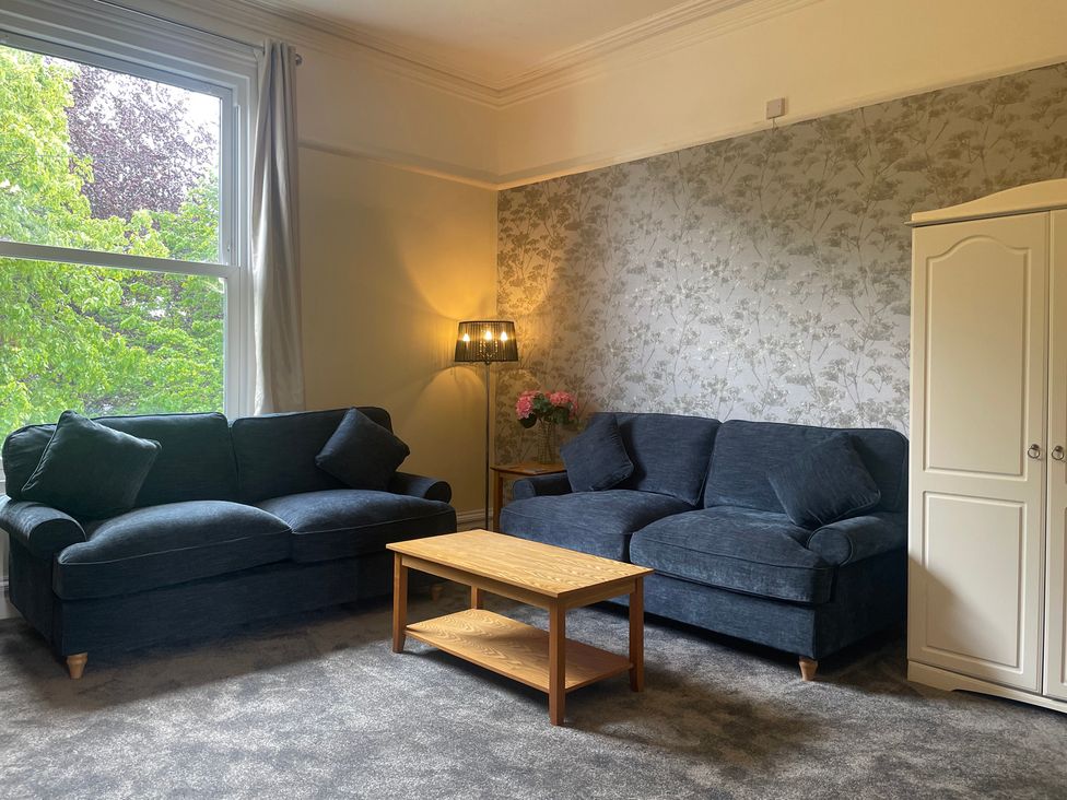 A living room with two sofas and a coffee table at Apartment 5 in Torquay