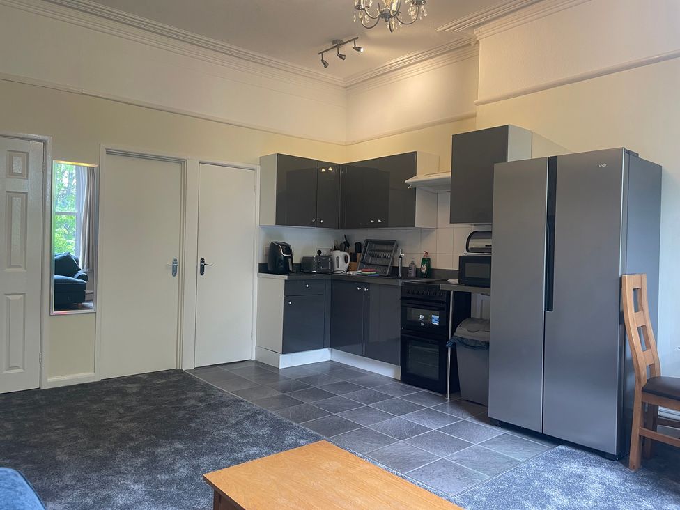A kitchen with cabinets and appliances at Apartment 5 in Torquay