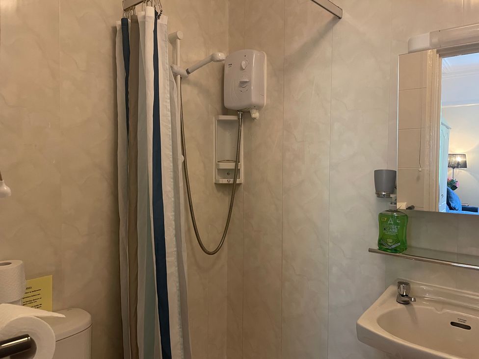 A bathroom with a shower and toilet at Apartment 5 in Torquay