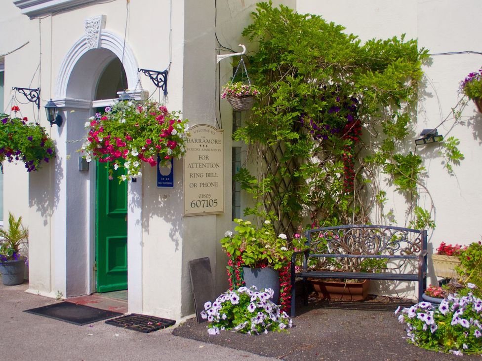 An entrance with a green door and planters at Barramore in Torquay